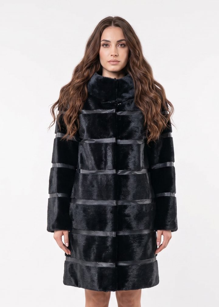 Woman wearing a black and gray striped coat on a white background. seal fur coat